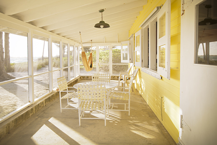 Spacious screen porch stretches the full front of Seagrape and features lighting, hammock, table and chairs.