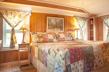 Spacious bedroom features comfortable king bed, ceiling fan and air conditioning.
