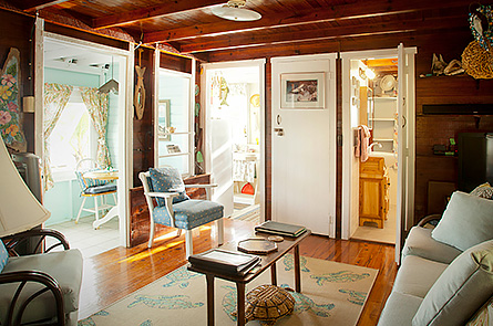 Open floor plan of living area offers wonderful light through the many windows, and breezy, fresh air keeps the cottage fresh.